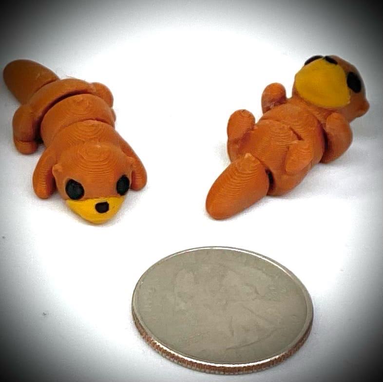 3d printed tiny articulated creatures, designed by Zou. Box of random minis.