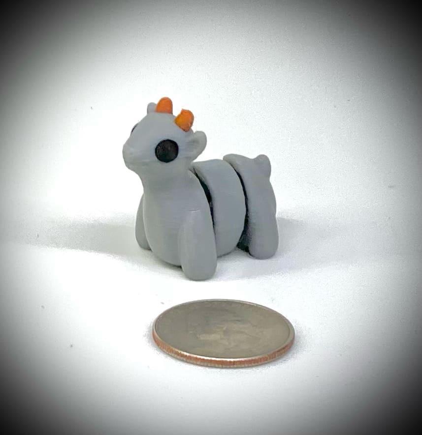 3d printed tiny articulated creatures, designed by Zou. Box of random minis.